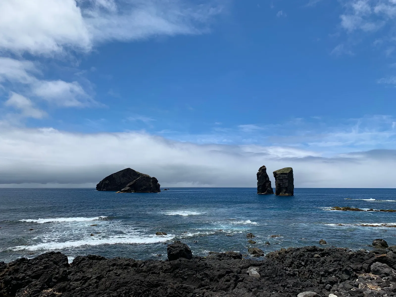 Black volcanic rocks and offshore islets on the coast at Mosteiros, Sao Miguel, the Azores