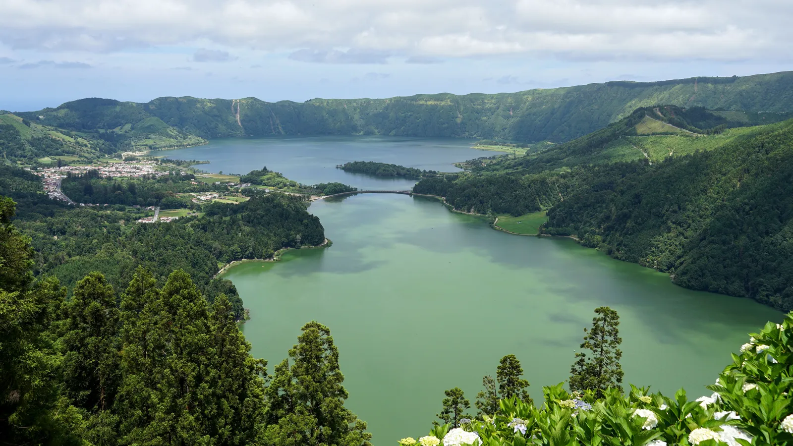 Twin crater lakes, one blue and one green, seen from a viewpoint above Sete Cidades on São Miguel in the Azores