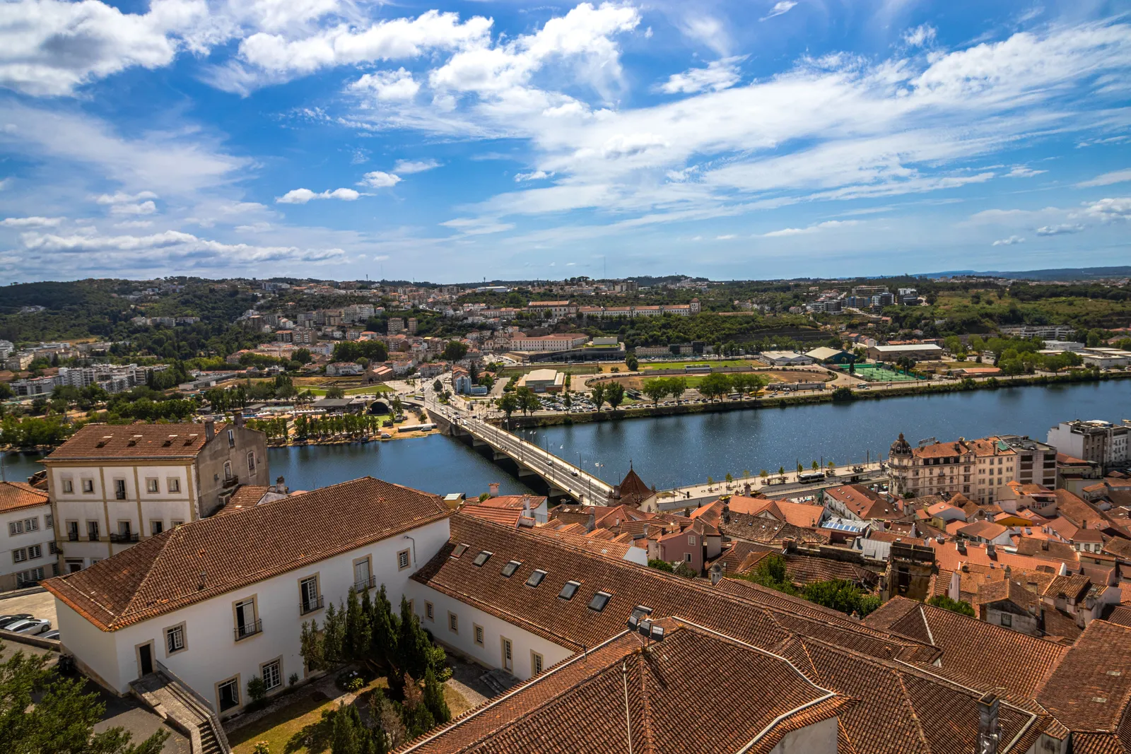 The historic university tower and old town of Coimbra rising above the Mondego River, Portugal