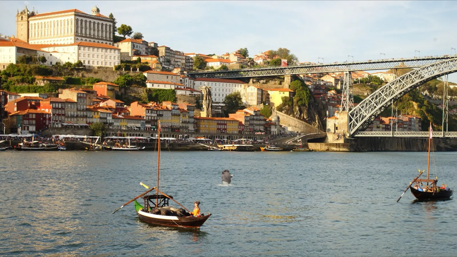 Traditional rabelo boats on the Douro river below the Dom Luis bridge in Porto