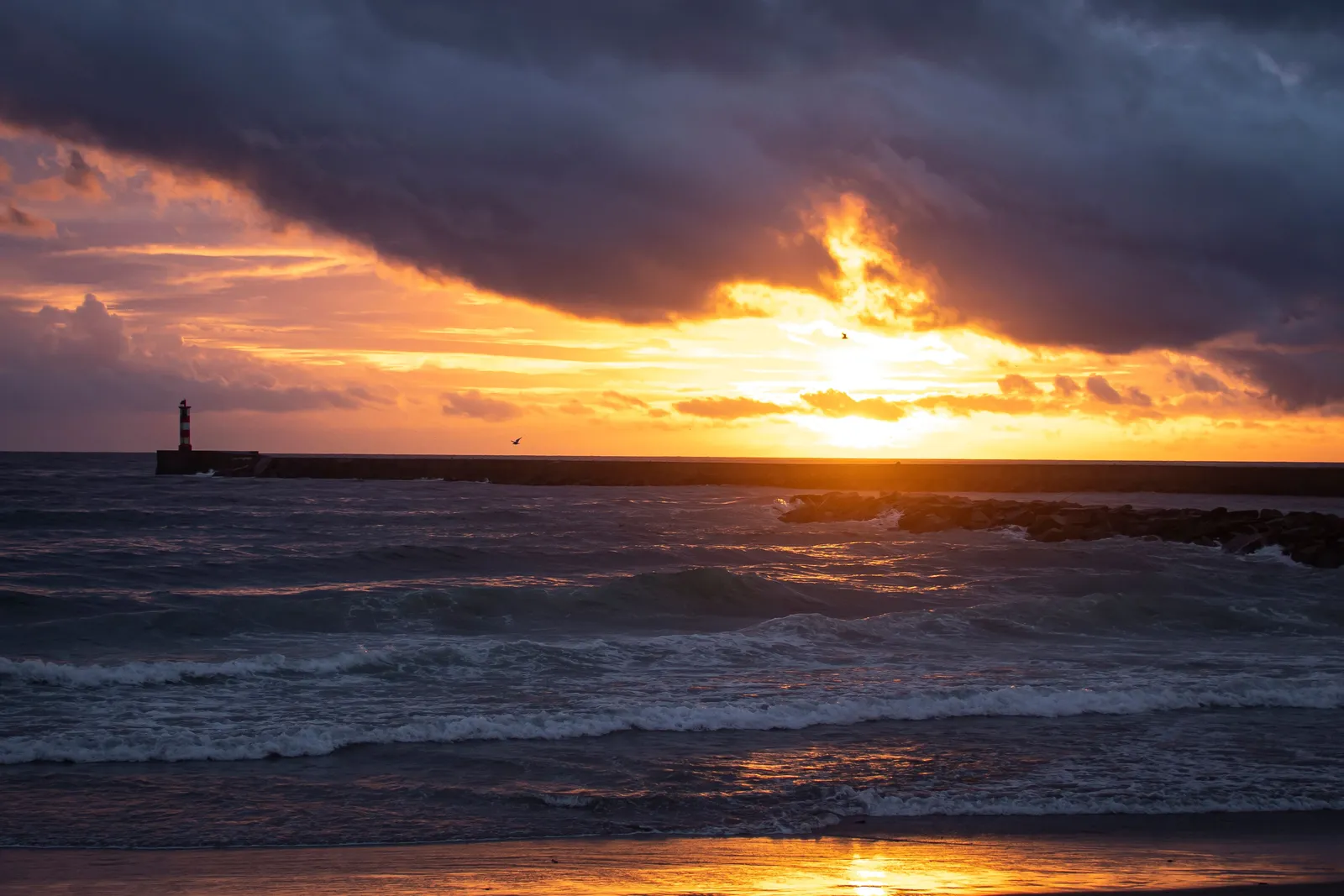 Heavy Atlantic surf breaking off the coast at Nazare, Portugal, at sunset