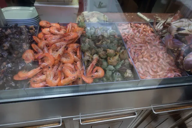 A chilled counter piled with fresh prawns, langoustines and crab