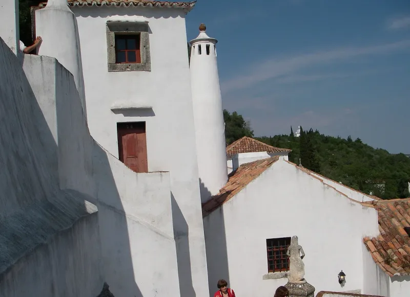 The white buildings of the Arrabida convent on the mountainside, facing the sea