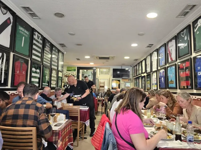 A room packed with diners, with framed football shirts on all the walls