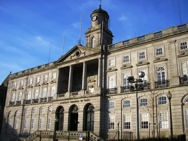A monumental neoclassical palace front with columns and a clock tower