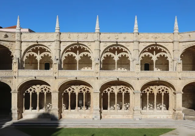 A cloister storey of richly carved stone arches