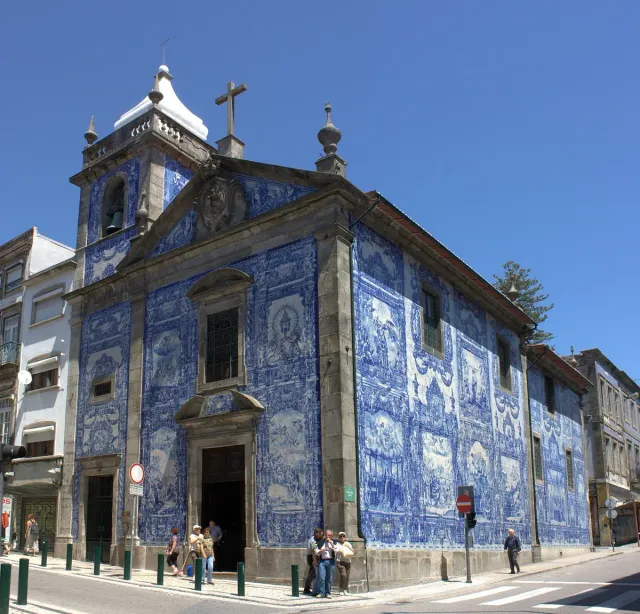 A chapel front covered in blue and white tiles with painted scenes