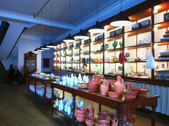 Lit shelves packed with ceramics and vintage design boxes