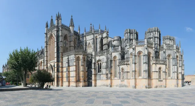A carved gothic monastery with pinnacles, buttresses and pointed windows