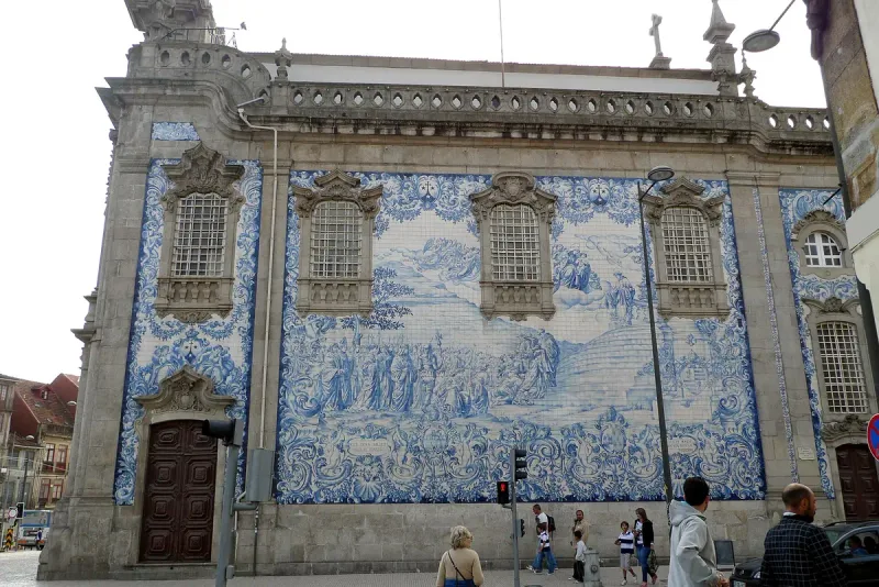 Entire church wall covered in blue and white azulejo tiles forming a painted scene