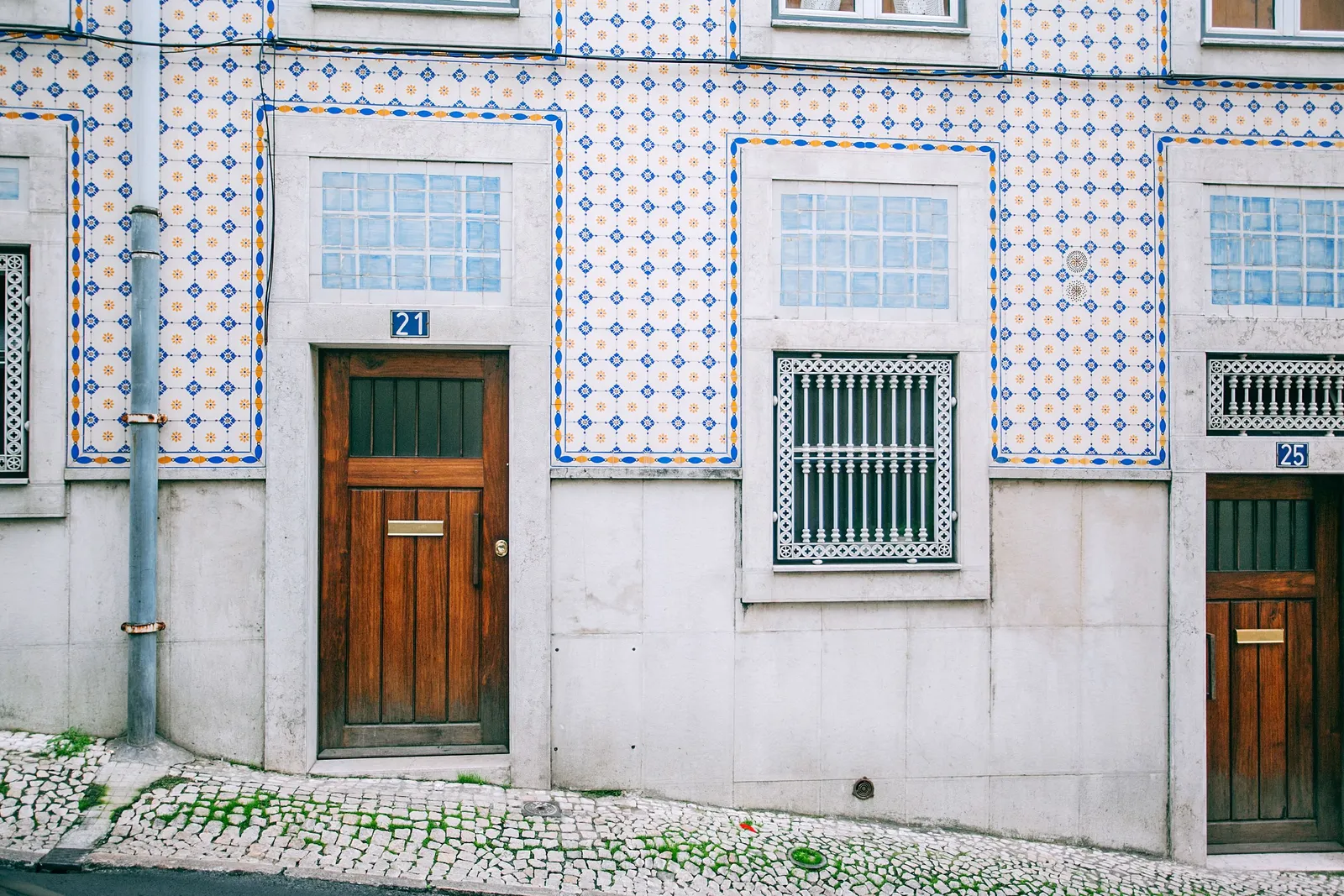 A quiet Lisbon street with tiled buildings, a scene typical of central Portugal's cities