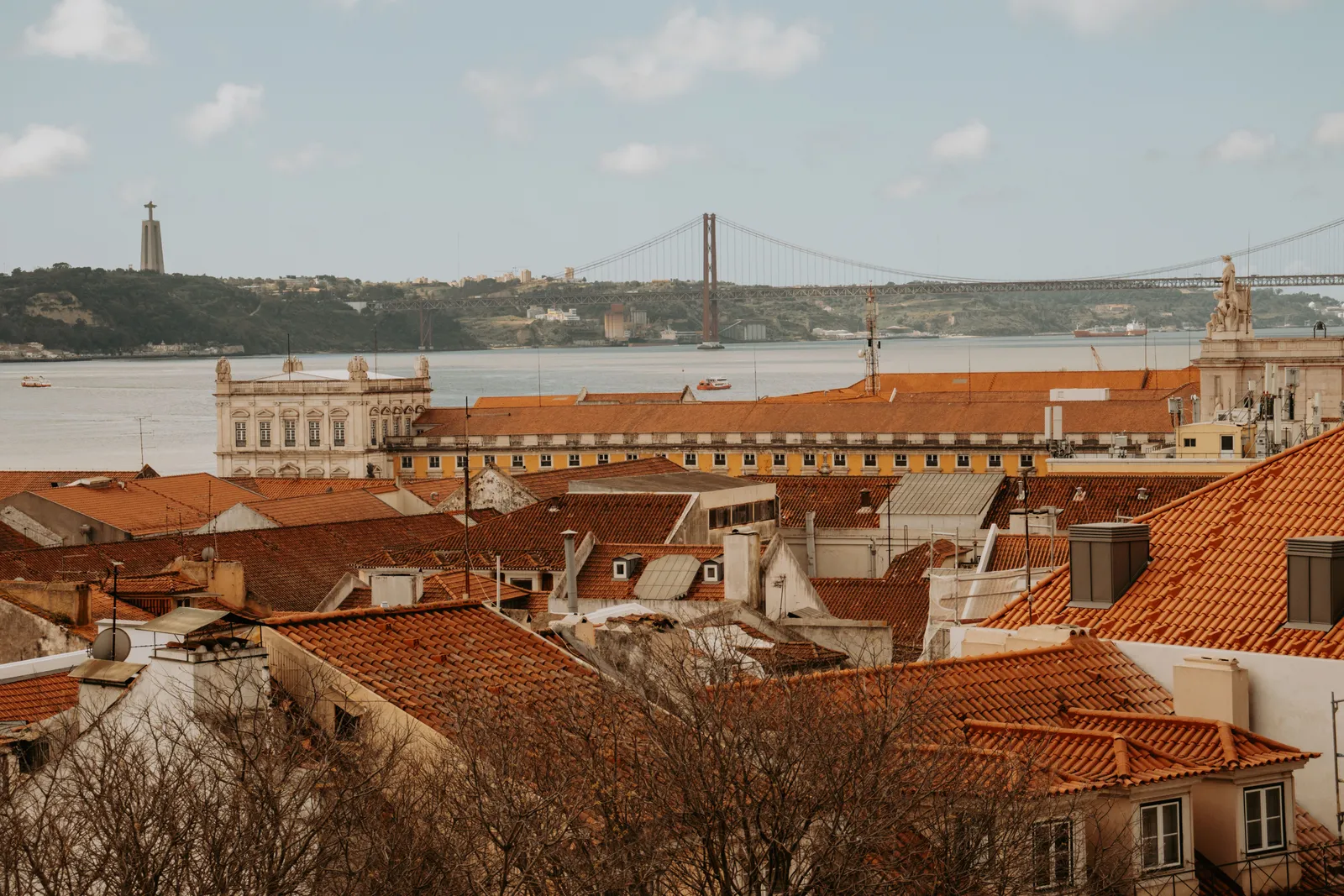 A viewpoint over the terracotta rooftops of Lisbon towards the bridge, Portugal